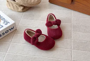 Detailed view showing the warm plush lining and bow of girls' wine red winter shoes