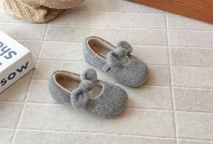 Close-up of grey fuzzy Mary Jane shoes for girls with bow detail and soft lining.