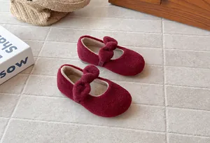 Close-up showing the soft plush material and bow detail of burgundy girls cotton shoes