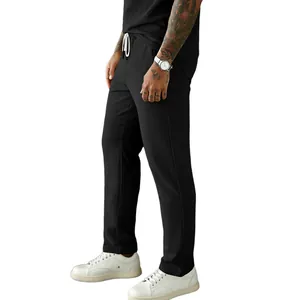 Close-up of black men's corduroy drawstring pants with casual straight-leg fit