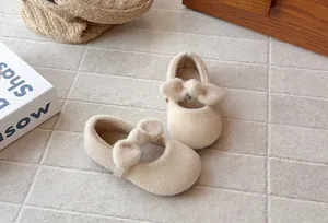 Close-up of fuzzy beige Mary Jane shoes with plush bow detail for little girls