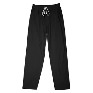 Close-up detail of black men's corduroy pants with white drawstring and elastic waist.