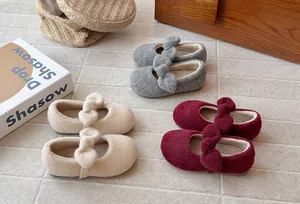 Variety of fleece-lined girls' Mary Jane shoes with fuzzy bows in winter colors