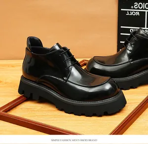 Detail view of men's glossy black leather boots with a rugged platform sole.