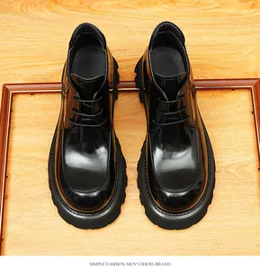 High-angle view of glossy black platform boots with sleek British business design