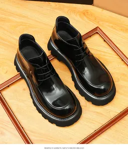 Detailed view of stylish men's shiny black thick-soled leather shoes in British style