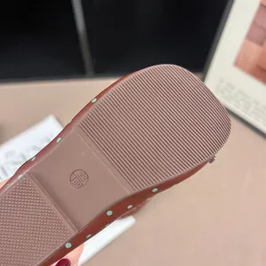 Macro view showing the anti-slip brown rubber sole of a polka dot toddler girl shoe