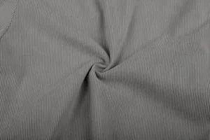 Close-up macro view of premium grey ribbed corduroy fabric texture for casual men's trousers