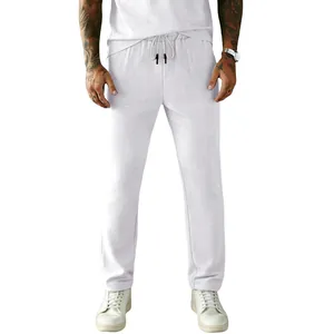 Detail shot of men's white corduroy casual pants with adjustable drawstring.