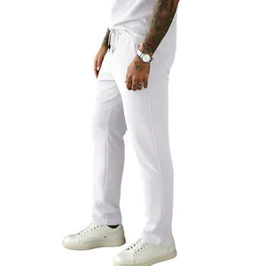 Detailed side profile of men's white corduroy drawstring trousers with ribbed texture
