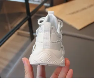 Rear view detail of white girls' mesh sneaker showing thick wavy sole