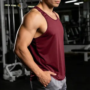Detailed side view of wine red quick-dry gym tank top on a muscular male model.