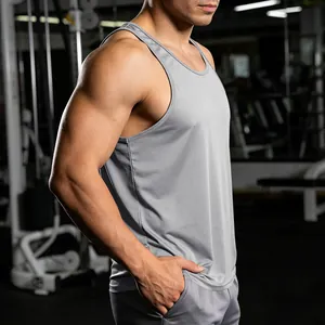 Side view detail of gray quick-dry gym tank top for men showing athletic muscle fit