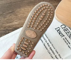 Close-up of non-slip rubber pebble sole of children's British style loafers.