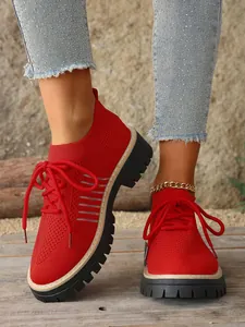 Detailed close-up of breathable red mesh lace-up platform sneakers for women's fashion