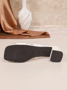 Bottom view of a stylish white block heel sandal showing anti-slip sole and size 37 mark