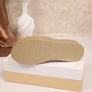 Detailed macro view showing the textured non-slip sole of women's gold platform wedge sandals