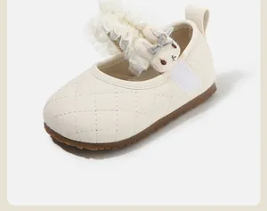 Detalle de zapato Mary Jane blanco para bebé con patrón acolchado y encaje de conejo
