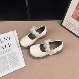 Elegant white Mary Jane girls' shoes with pearl ruffles and British style soles.