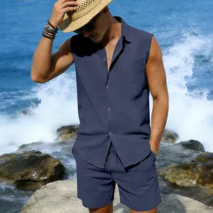 Detail view of the men's navy blue sleeveless linen set styled with a straw hat at beach
