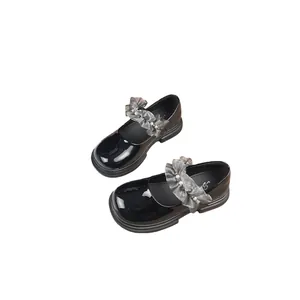Elegant black patent leather girls' Mary Janes with grey lace and pearl strap