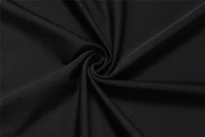 Macro detail shot showing the premium texture of soft black fabric for women's skirt set.