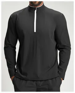 Close-up of black men's sports jacket featuring contrast white half-zip and mock neck detail