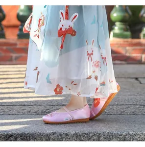 Close-up of pink silk embroidered shoes for girls paired with a traditional Hanfu dress
