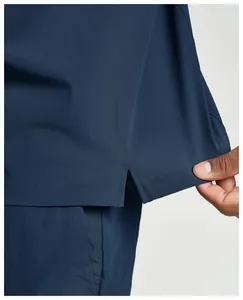 Detailed view of the side slit and reinforced stitching on a navy blue quick-dry sports jacket