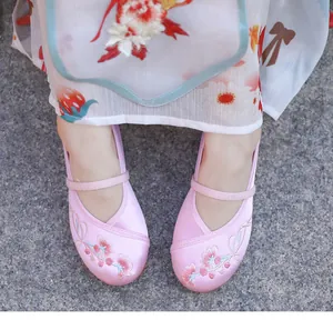 Detailed view of pink embroidered floral Hanfu shoes for girls for dance performance