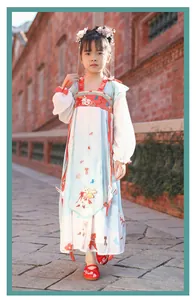 Detailed view of red embroidered shoes for girls worn with a traditional Hanfu dress