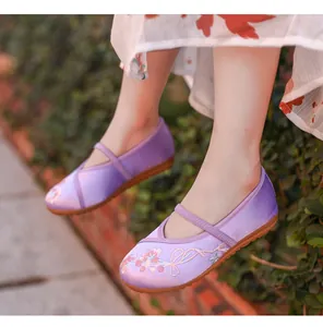 Detailed shot of purple embroidered Hanfu shoes for girls with floral patterns and strap
