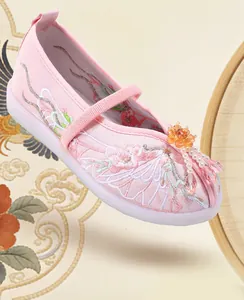 Close-up of pink embroidered Hanfu style shoe with beaded flower and pearl tassels