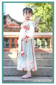 Detailed view of girls' traditional embroidered fabric shoes worn with a Hanfu dress