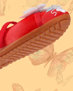 Detailed view of red Hanfu shoe for girls featuring butterfly applique and sole texture