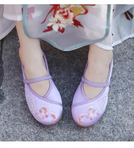 Detailed embroidery of pink flowers on purple traditional Chinese Hanfu shoes for girls