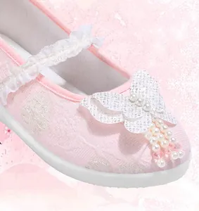 Detailed close-up of pink girls Hanfu embroidered shoe featuring butterfly and pearls