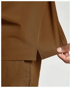 Detailed macro view showing the side slit hem and fabric texture of a men's sports jacket.