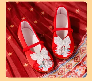 Close-up of red Hanfu embroidery shoes for girls with lace butterfly and pearl details