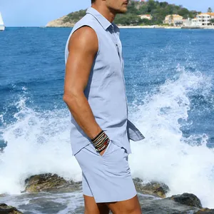 Detail view of a man wearing a light blue sleeveless linen shirt and matching shorts set beach.