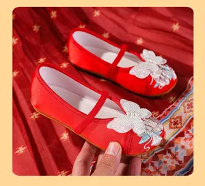 Detailed view of red Hanfu embroidered shoes for girls with white butterfly and pearls