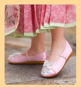 Detailed view of pink girls' traditional Hanfu shoes featuring butterfly embroidery and pearl