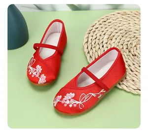 Detail view of traditional red embroidered Chinese shoes for girls, Hanfu style.
