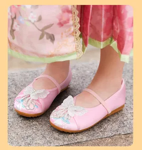 Close-up of pink embroidered Hanfu shoes for girls with butterfly and pearl details