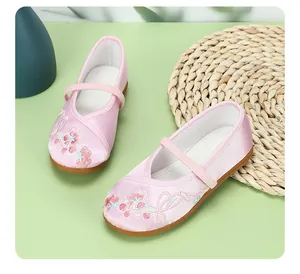 Close-up of pink children's embroidered Hanfu shoes with floral satin finish