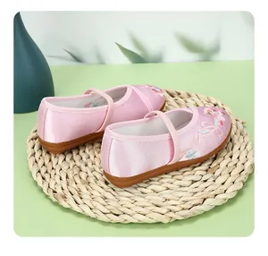 Detailed macro view of pink traditional Chinese embroidered Hanfu shoes for girls