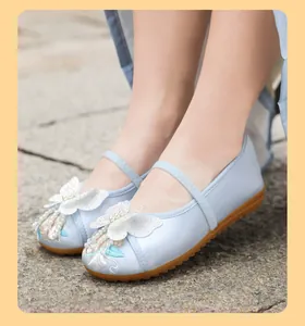 Detailed view of girls traditional Hanfu shoes with 3D butterfly and floral embroidery