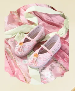 Detailed view of pink Hanfu embroidered shoes for girls with floral patterns and tassels