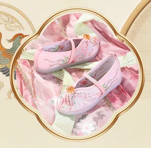 Detailed view of pink embroidered Hanfu shoes for girls with pearl tassel decor
