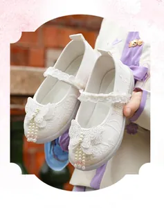 Detailed view of white Hanfu shoes for girls with glittery butterfly and pearl beads